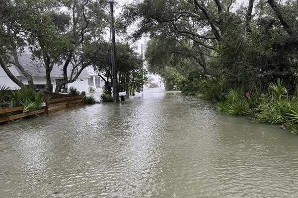 North Beach flooded street flowing into residential properties