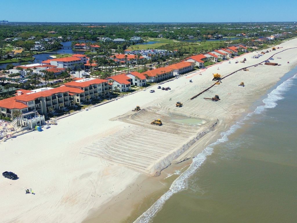 Beach restoration work being doing along a line of beachfront condos.