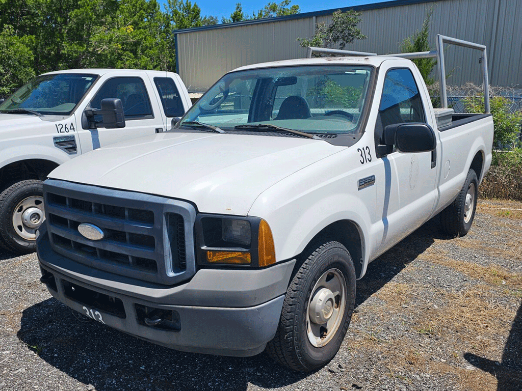 front and side view of older white work truck