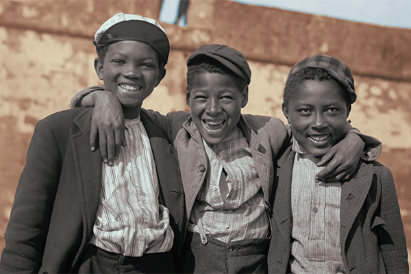 Three happy, smiling African American boys in sepia tint photo