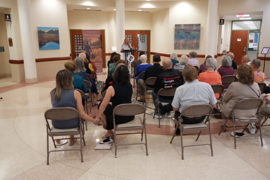 Commissioner Joseph speaking to a crowd at the Art in Public Spaces program opening reception.