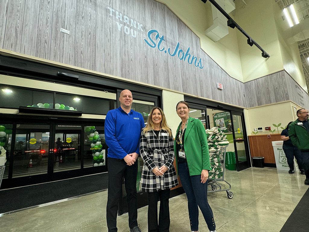 Commissioner Ann Taylor posing with Sprouts Farmers Market staff