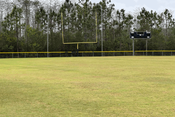 A goalpost and scoreboard at one end of a football field