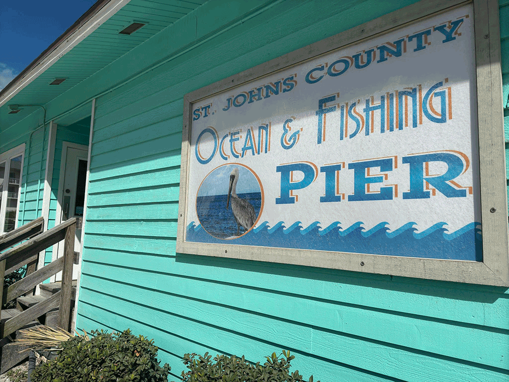 The sign on the front of the St. Johns County Ocean and Fishing Pier Gift Shop