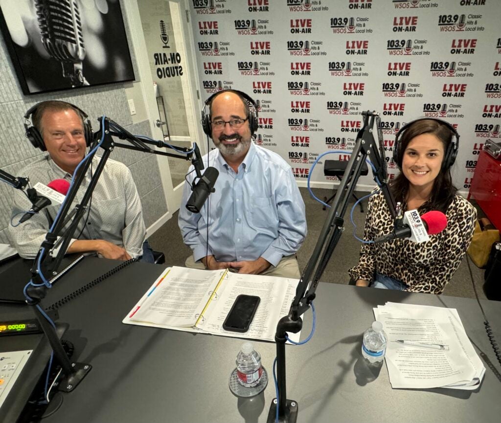 Commissioner Arnold in front of a microphone at the WSOS radio show.